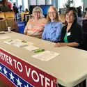 Student leaders and members of AAUW help community members register to vote. 