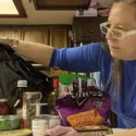 Liz Otterness throwing away food at her home that contain sugar