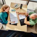 students studying at a table inside a campus building