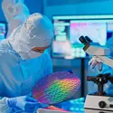 Semiconductor employee examining wafer