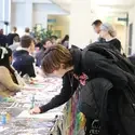 A student adds their name to a club signup sheet during the College of Western Idaho's Club Fest and Student Resource Fair.
