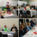 Group of people gathered around tables in a meeting room, socializing and participating in holiday activities.