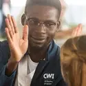 A nursing student gives a "high five" to a donor during a luncheon.