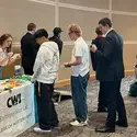 Students line up to register at an entrepreneur week table.