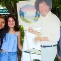Art Club students posing with a cut out of Bob Ross