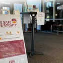 Be Safe, Be Mighty sign and sanitizing station on campus
