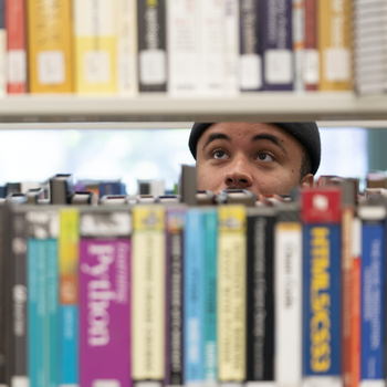 Person behind a set of books