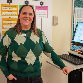 Person standing next to a computer