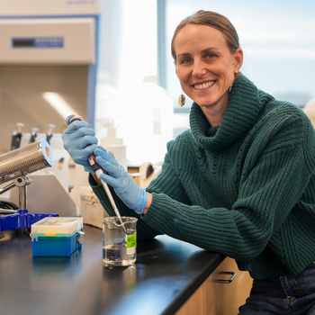 Elise Connor with a pipette at a lab counter