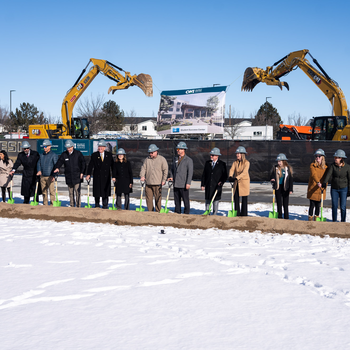 Dignitaries stand with shovels for a ceremonial groundbreaking.