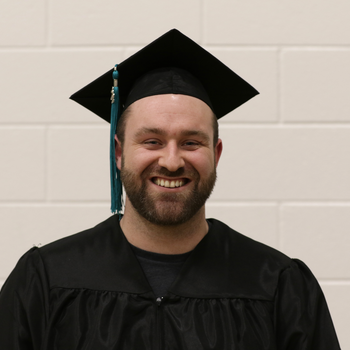 Smiling graduate dressed in regalia