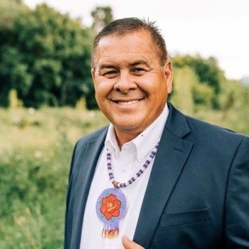 Portrait of Darren Parry standing in grass