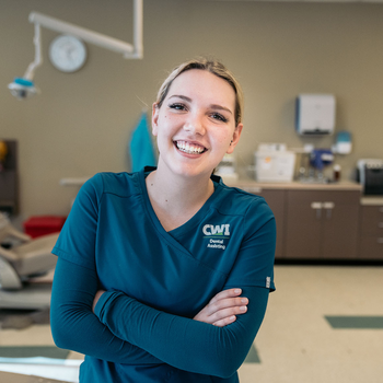 A student of CWIs Dental Assisting program smiles at the camera.