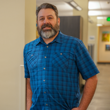 Person stands next to pillar and table