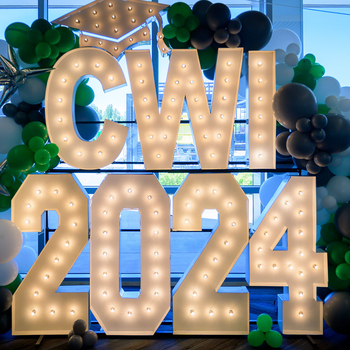 A display is pictured, comprised of large letters that say "CWI 2024" and are surrounded by balloons.