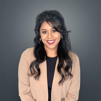 Woman with long dark hair smiles at camera