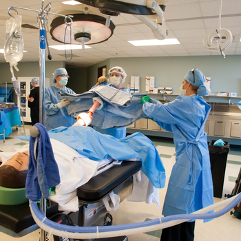 Medical students are trained in a practice lab that simulates an operating room.