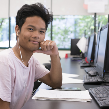 Student in computer lab with headphones in