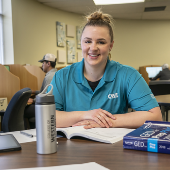 Person sitting in testing center smiling at camera