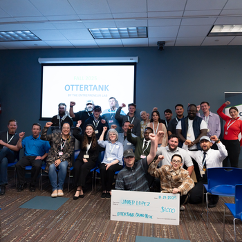 Group of people cheering in front of projector screen