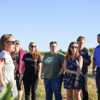 Andrea Schumaker addressing group in Campus Garden
