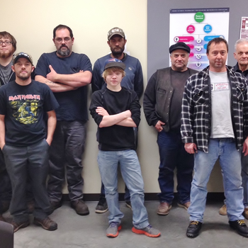 Group of welding students in back of classroom