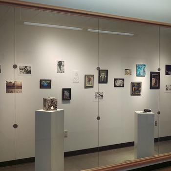 An image of a gallery wall featuring artwork by students from the College of Western Idaho.