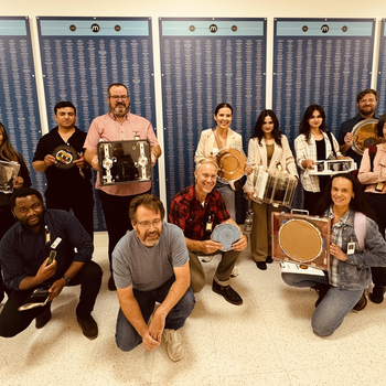 Group of people holding technology and tools