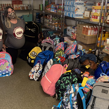 SNA President, Melissa Brown, left, and Lizzie Glafke, SNA Project Coordinator, donating backpacks