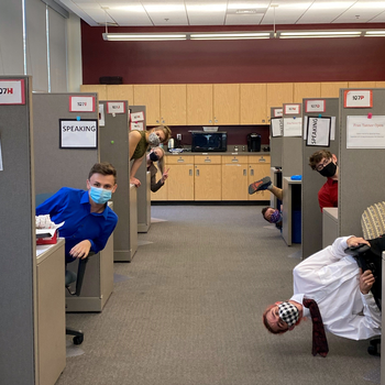Speech and Debate team members competing virtually from cubicles on campus during their first tournament of the 2020-2021 season