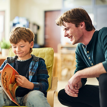 Student working with young boy