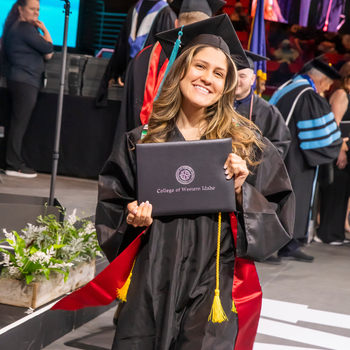 Honors graduate holding diploma cover