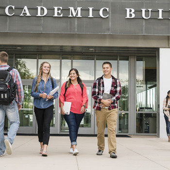 CWI students walking in front of the academic building