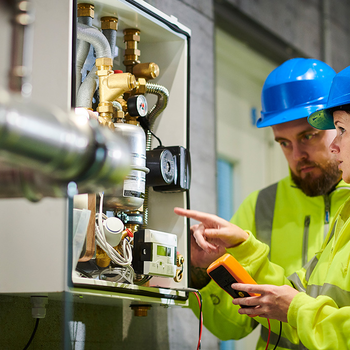 Plumbing apprentice learning on the job.