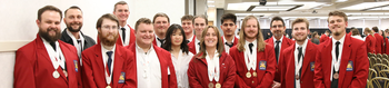 Group of students posing for a photo wearing SkillsUSA blazers with awards around their necks