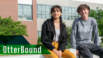 Two students outside a campus building, OtterBound text over image