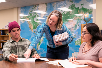 ELL students in a classroom working with a teacher