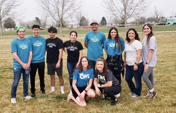Students wearing CWI shirts in a group outdoors smiling at the camera