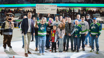 Group of administration, staff, and students on the ice at CWI Night at the Idaho Steelheads for the scholarship giveaway