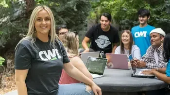 Students sitting at table outside studying