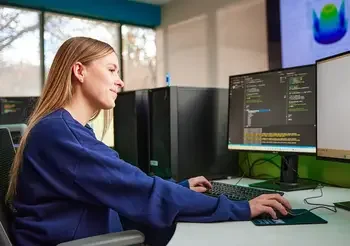 Student in a computer classroom and the Ada County Campus Pintail Building
