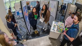 Students on campus at the annual Connections Conference by their posters
