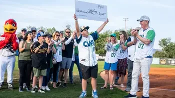 Hawks mascot with CWI students and employees on the field at CWI Night at the Hawks