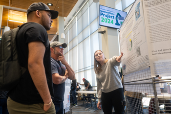 Student showcasing a poster