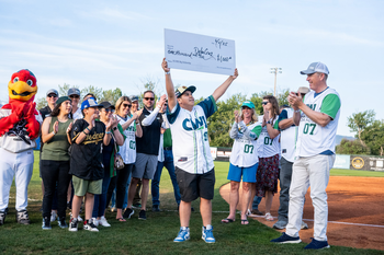 Hawks mascot with CWI students and employees on the field at CWI Night at the Hawks