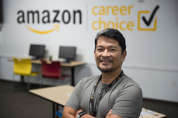 Amazon employee in front of the Amazon Career choice logo