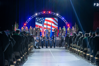 student signing national anthem from center aisle perspective