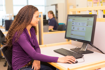 Smiling girl behind computer