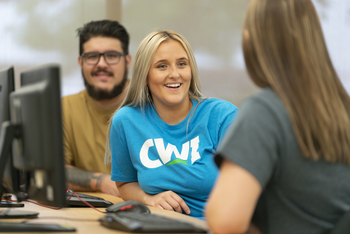 Students talking in a computer lab. 