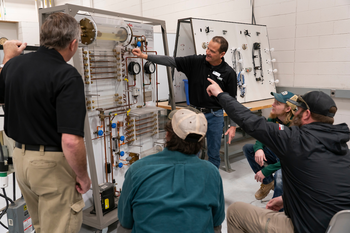 HVAC instructor instructing a group of students